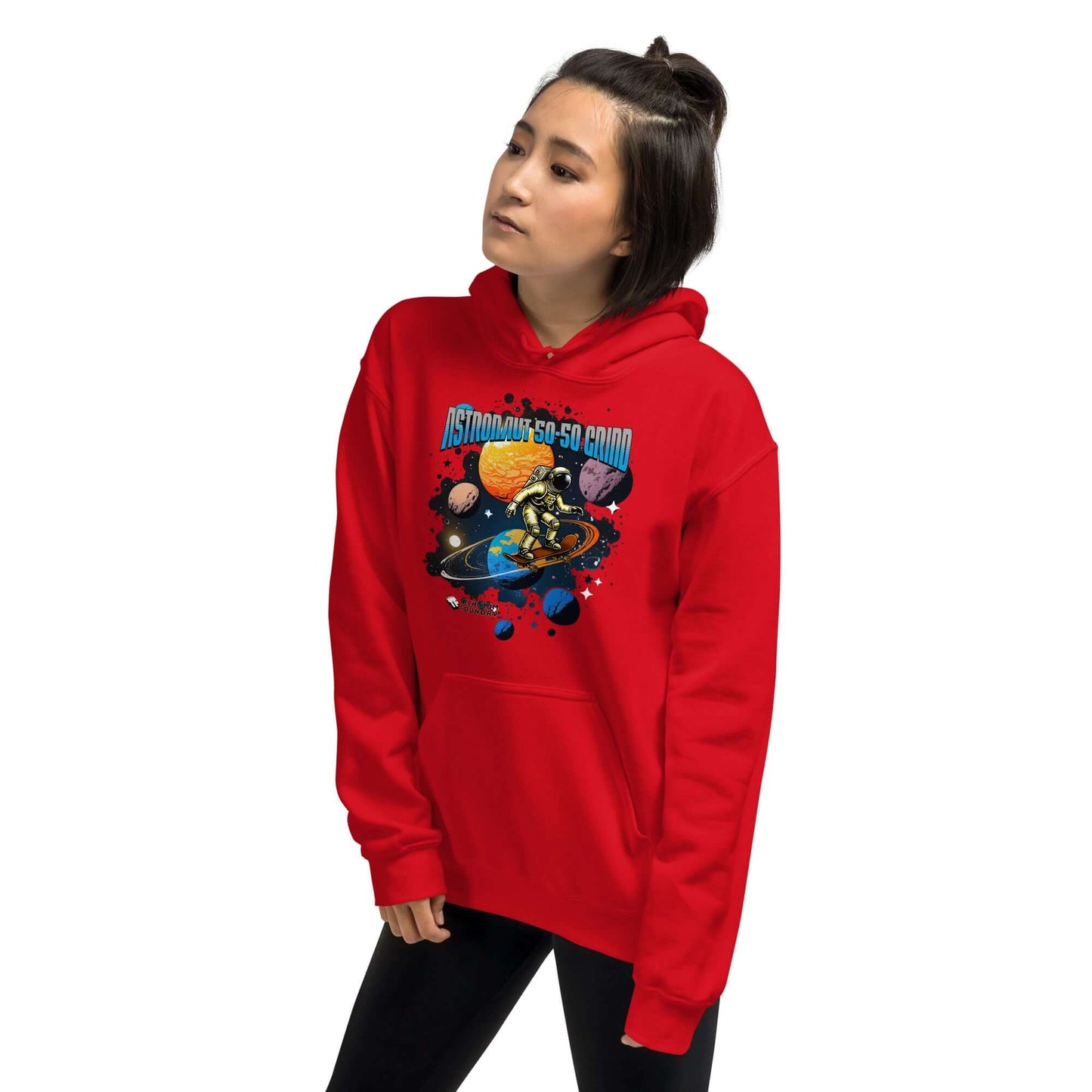 Woman wearing red hoodie with an astronaut skateboard design, showcasing the "Astronaut 50-50 Grind" print by Technium Foundry.