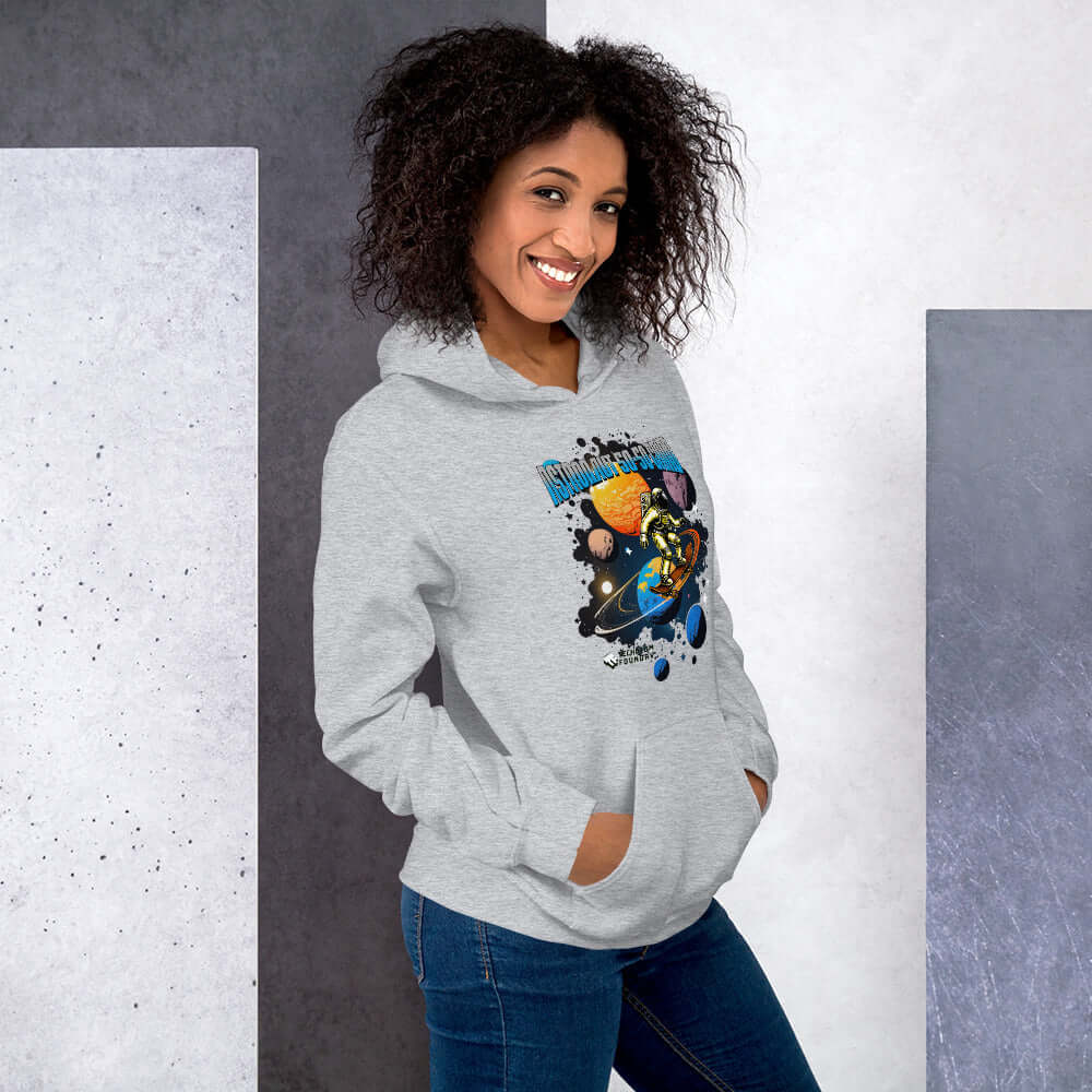 Woman wearing a grey Astronaut 50-50 Grind Hoodie with cosmic skater design by Technium Foundry, featuring vibrant space graphics.