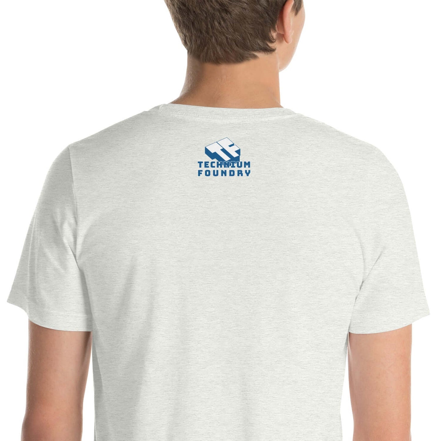 Back view of light gray T-shirt featuring Technium Foundry logo in blue.