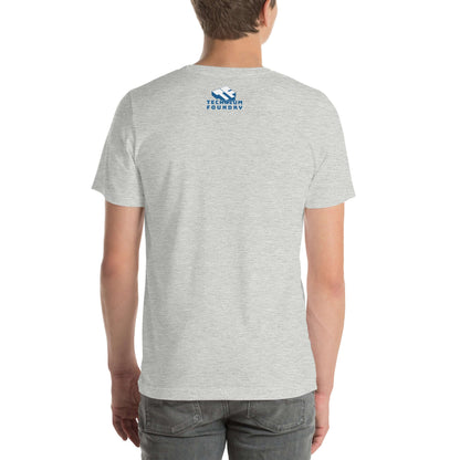 Back view of a gray t-shirt with blue "TechHum Foundry" logo on upper back, paired with jeans.