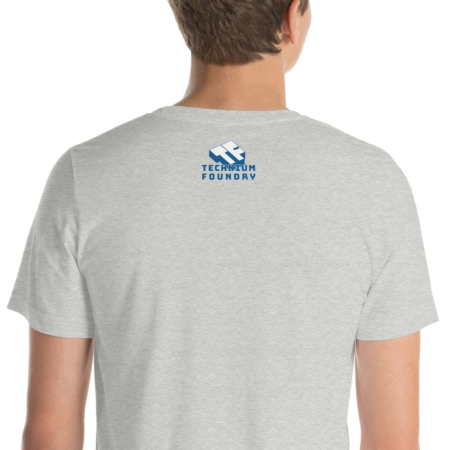 Back view of a gray T-shirt featuring the Technium Foundry logo, ideal for tech enthusiasts and casual wear.