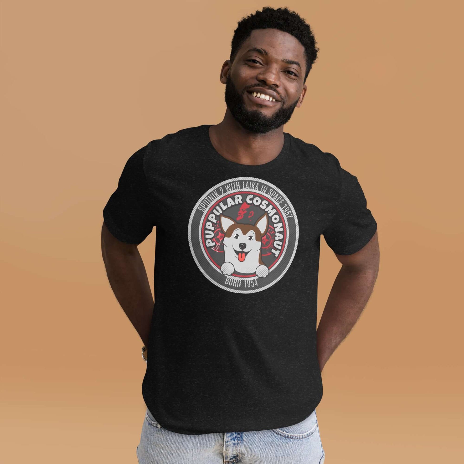 Man wearing Puppular Cosmonaut T-shirt featuring retro Laika space dog design on a beige background.