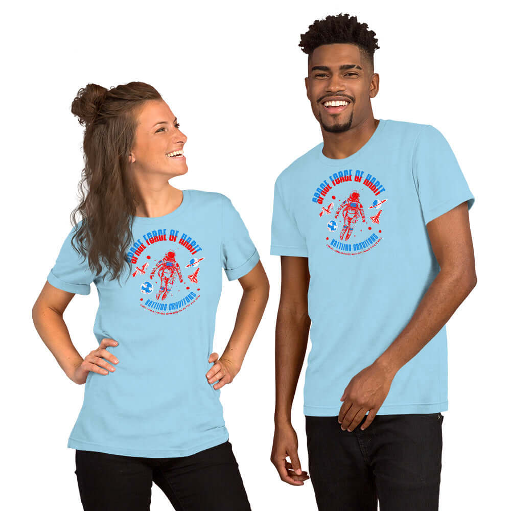 Two models wearing "Space Force of Habit" astronaut humor t-shirts, featuring a playful cosmonaut design on light blue fabric.