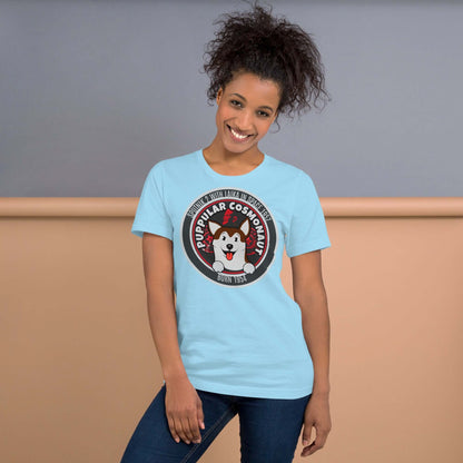 Woman wearing Puppular Cosmonaut T-Shirt featuring a retro Laika space dog design on a light blue background.