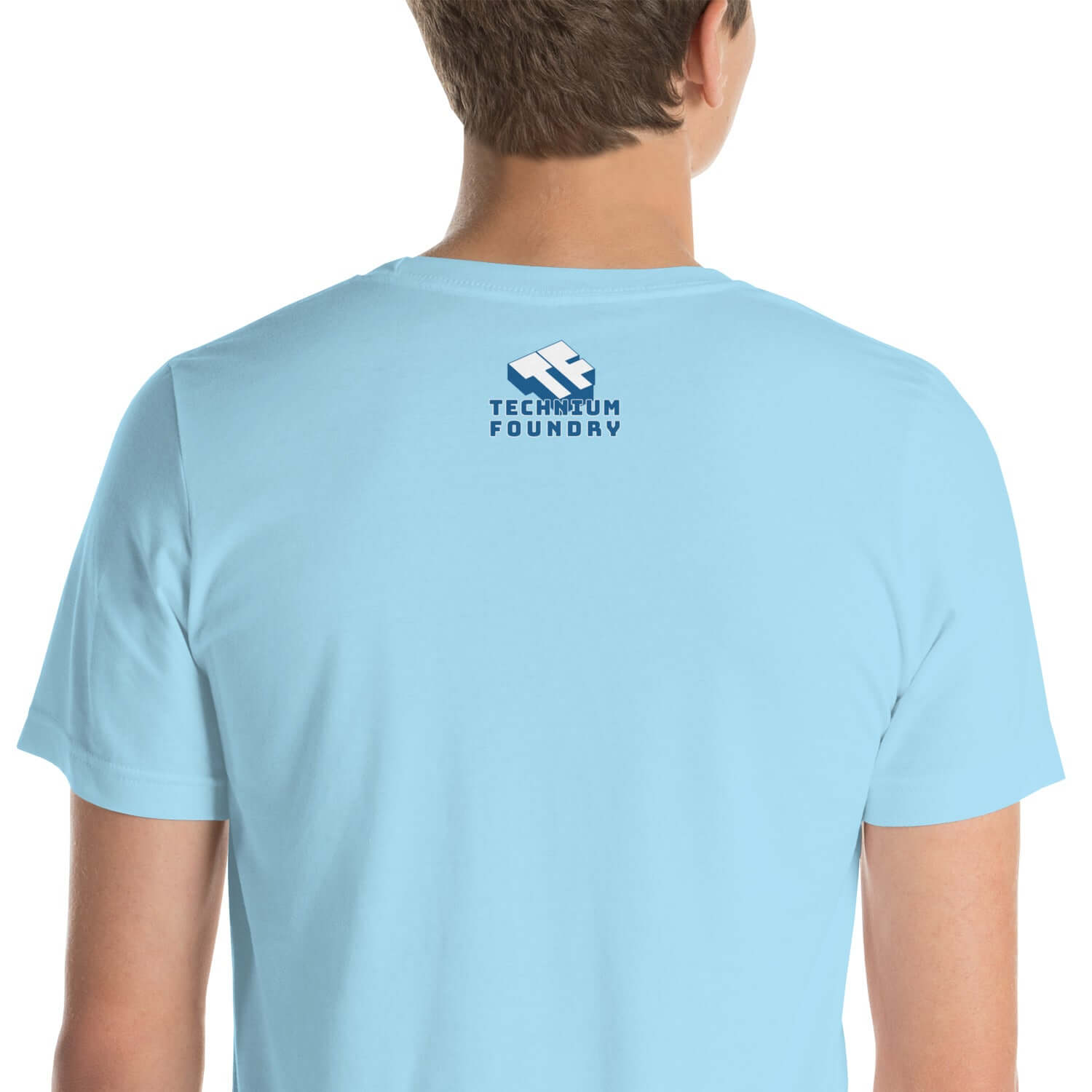 Back view of a light blue T-shirt featuring Technium Foundry logo on the upper back.