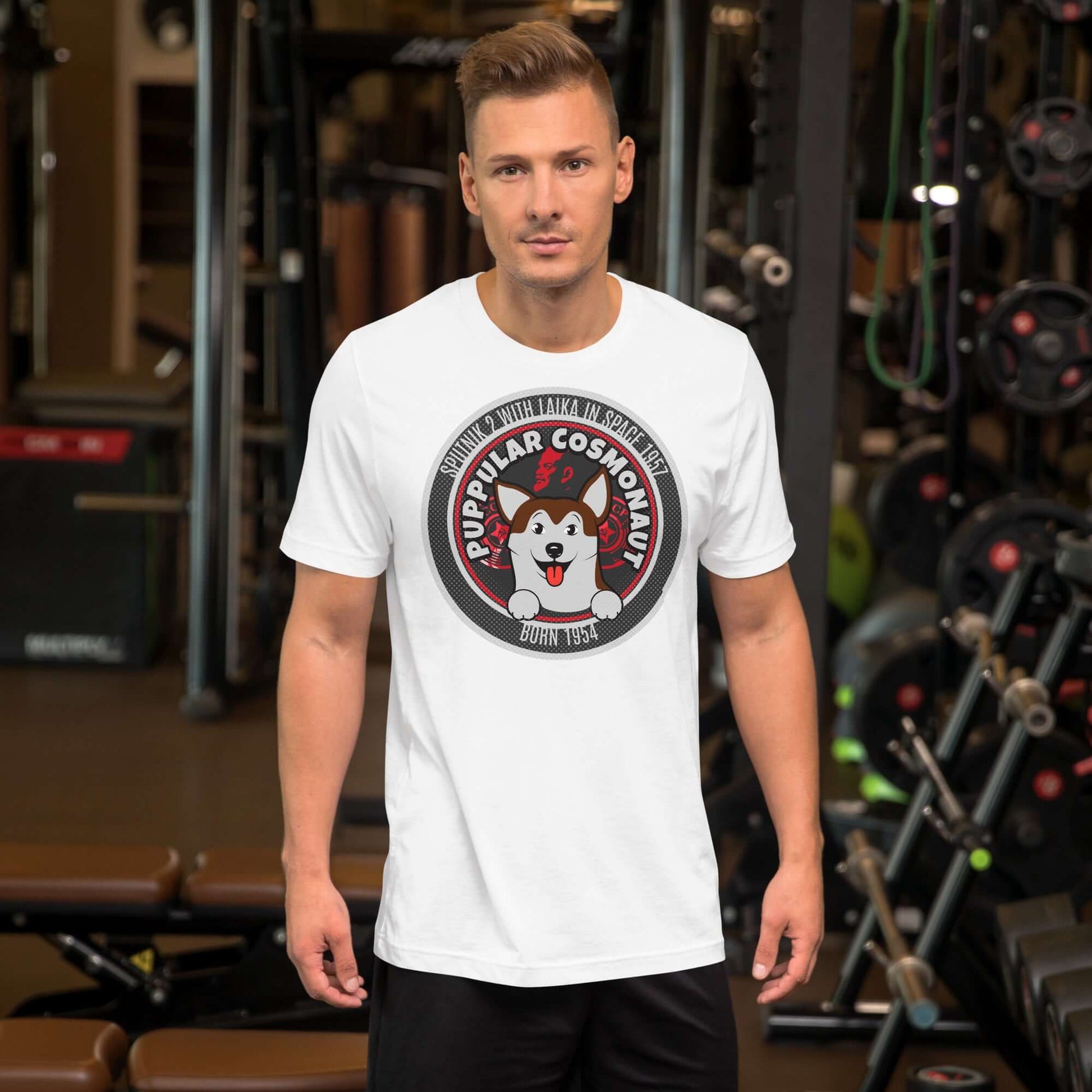 Model wearing Puppular Cosmonaut T-Shirt with retro Laika space dog emblem in a gym setting.