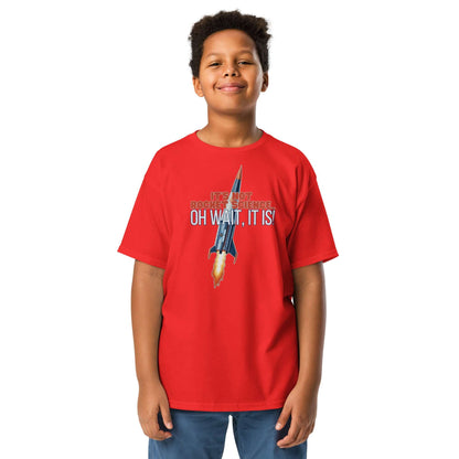 Boy wearing red "It's Not Rocket Science... Oh Wait, It Is!" tee with rocket graphic and humorous text.